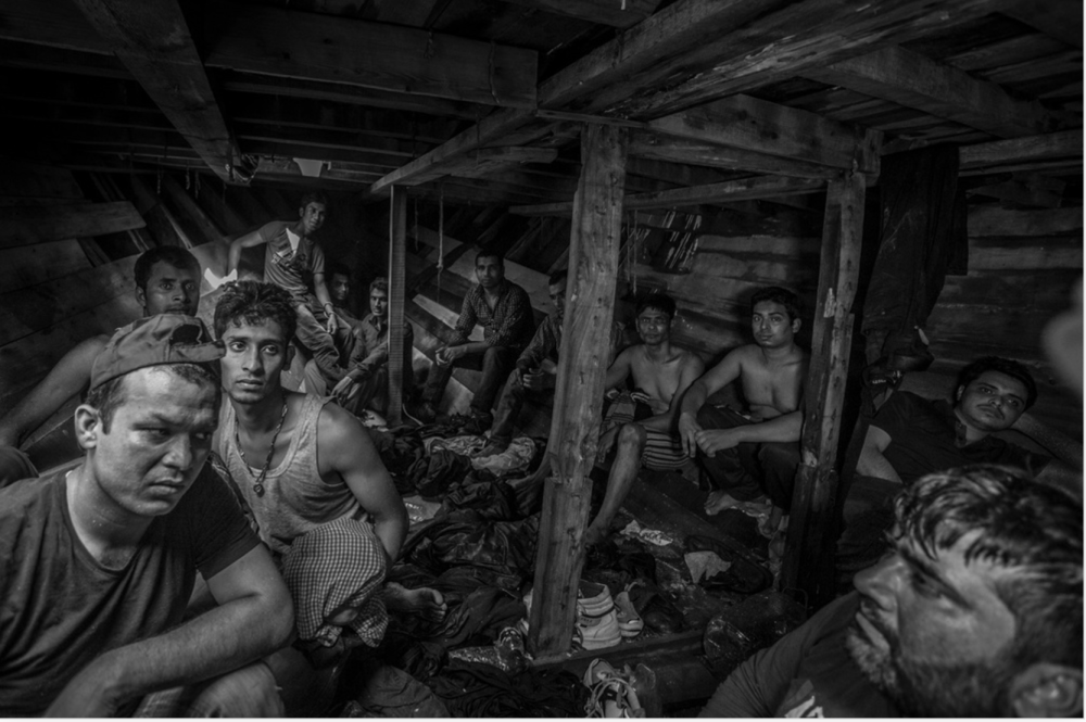 Bangladeshi and Pakistani migrants wait to be evacuated from the fetid hold of a smuggler’s boat off the coast of Libya. © Jason Florio/MOAS. Photojournalism Series Winner, Magnum Photography Awards 2017.