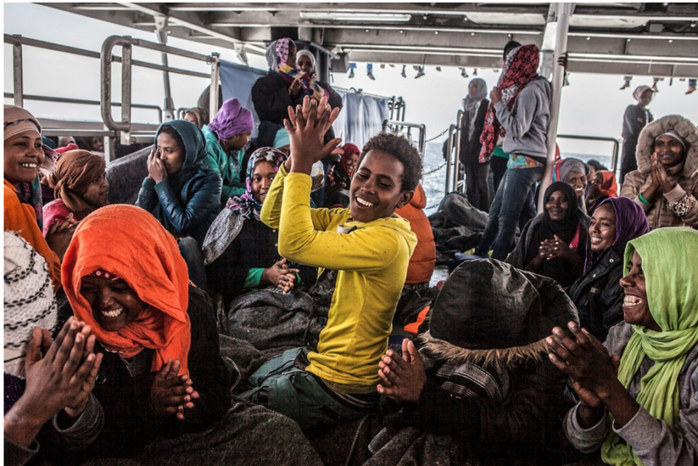 Unaccompanied Eritrean minor, Henock, onboard rescue ship, leads refugees in song of thanks. ©Jason Florio